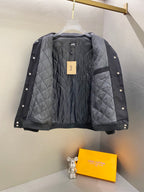 Black quilted snap-front jacket with ribbed cuffs, logo patch at chest