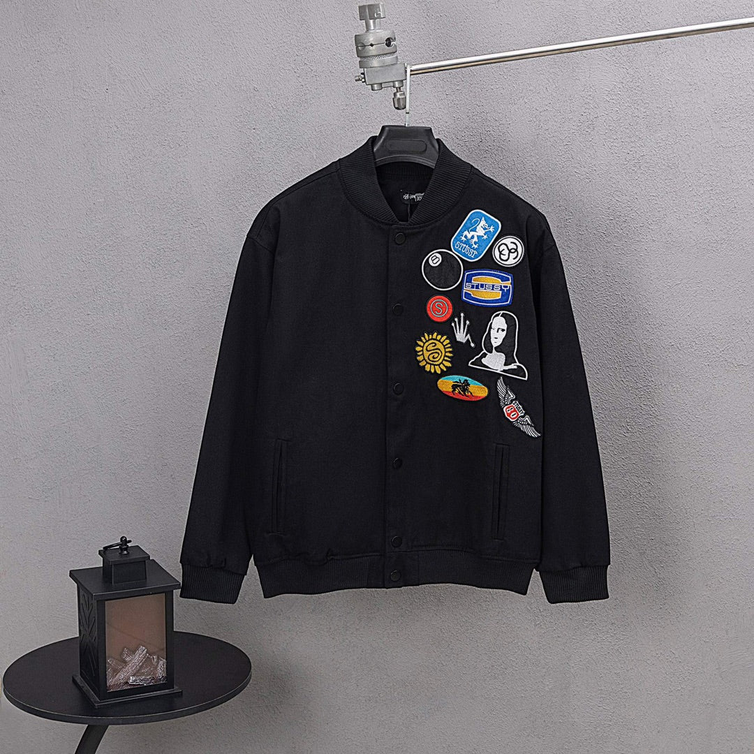 Stussy black bomber jacket, chest patch graphics on button-front