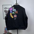 Black Stussy bomber jacket with large multicolor back patch graphic
