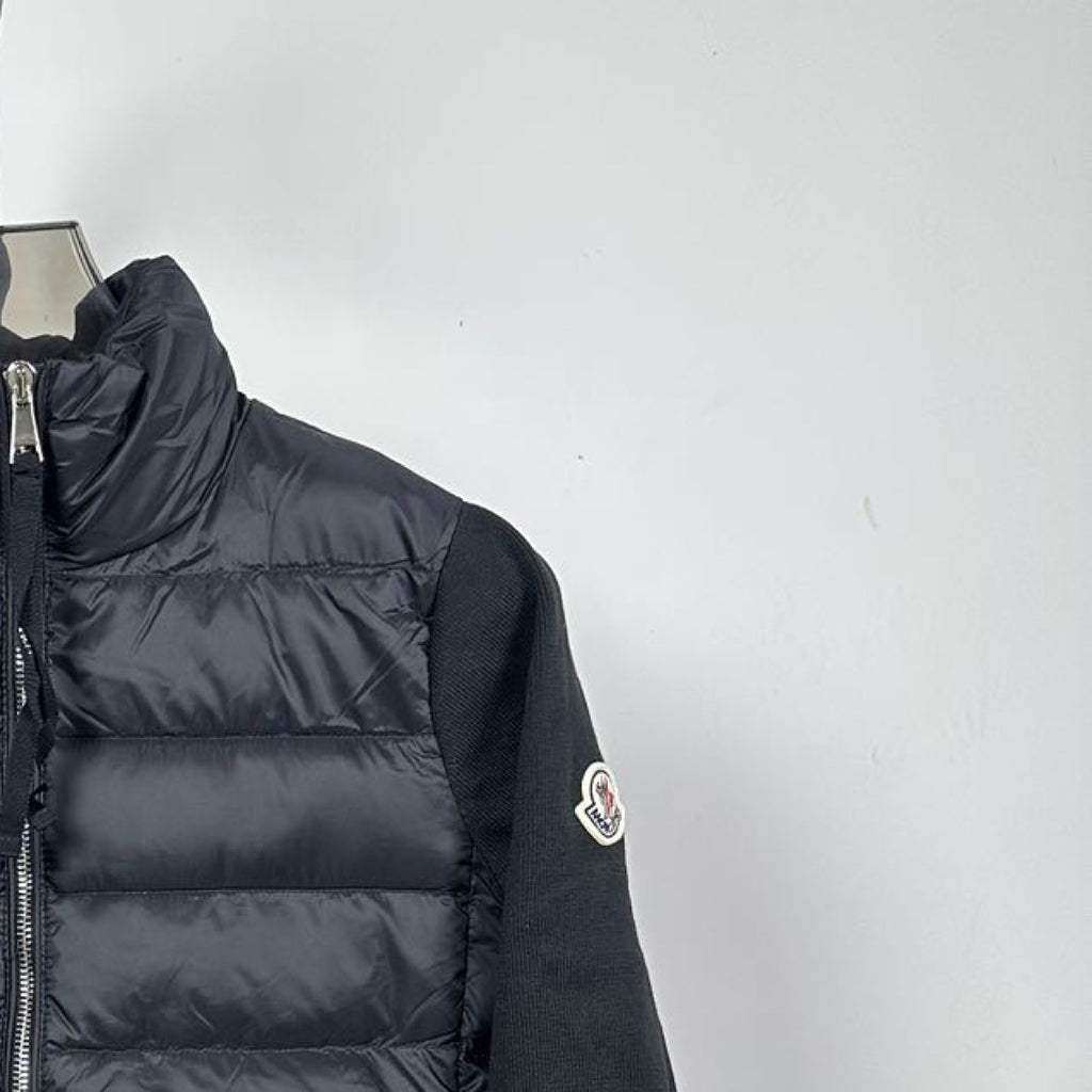 Moncler long puffer jacket side view with sleeve logo patch and quilted body