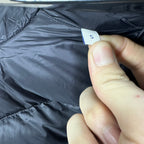 Moncler long puffer jacket fabric close-up with size tag marked S