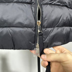 Moncler long puffer jacket close-up of full-zip front with metal zipper pull