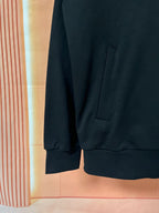 Dark hoodie sleeve cuff and front pocket panel detail