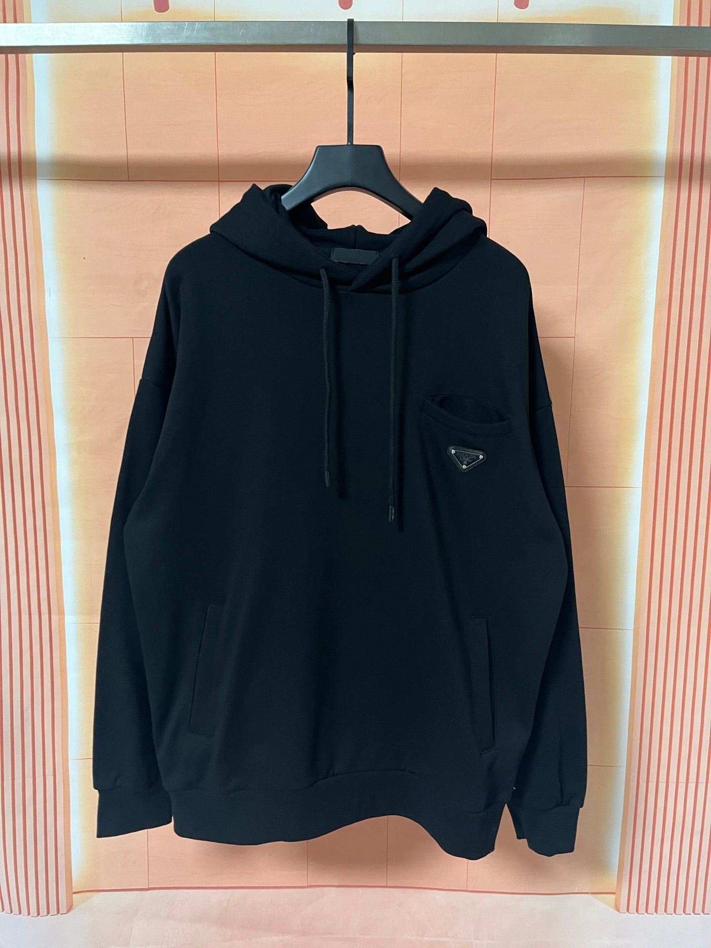 Prada dark hoodie with hood, drawstrings, and front kangaroo pocket