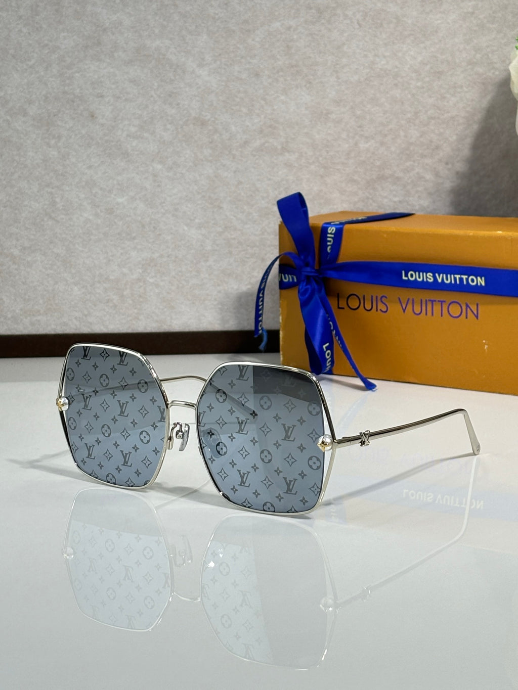 Louis Vuitton sunglasses with blue monogram frames and tinted lenses