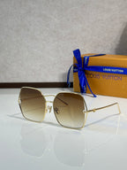 Louis Vuitton sunglasses with gold-tone frame and light beige tinted lenses