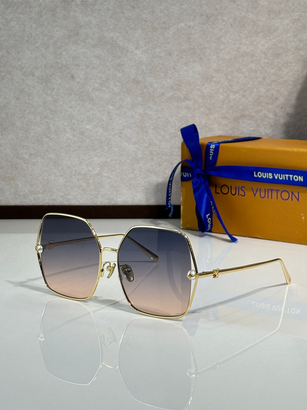 Louis Vuitton sunglasses with gold-tone frame and dark gradient lenses