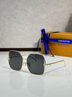 Louis Vuitton sunglasses with gold-tone frame and black gradient lenses