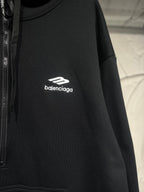 Black Balenciaga hoodie with white chest logo and drawstring hood.