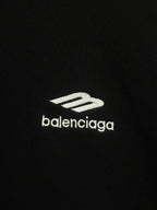 Balenciaga white logo print on black hoodie fabric.