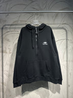 Black Balenciaga zip-up hoodie with hood, drawstrings, and front pouch pocket.
