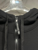 Black hoodie zipper with branded tape and metal zipper pull.