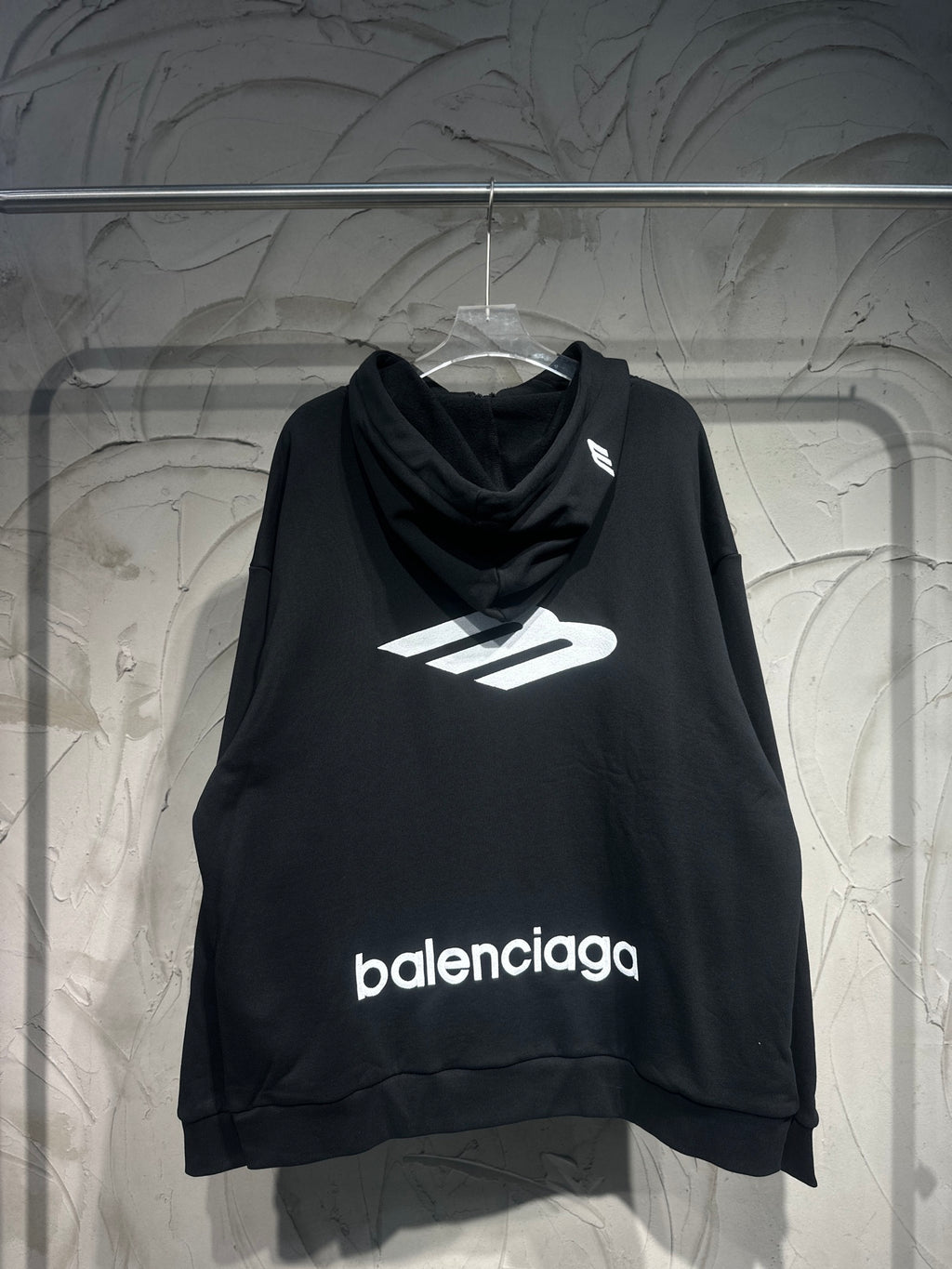 Black Balenciaga hoodie with front logo print and cowl neckline