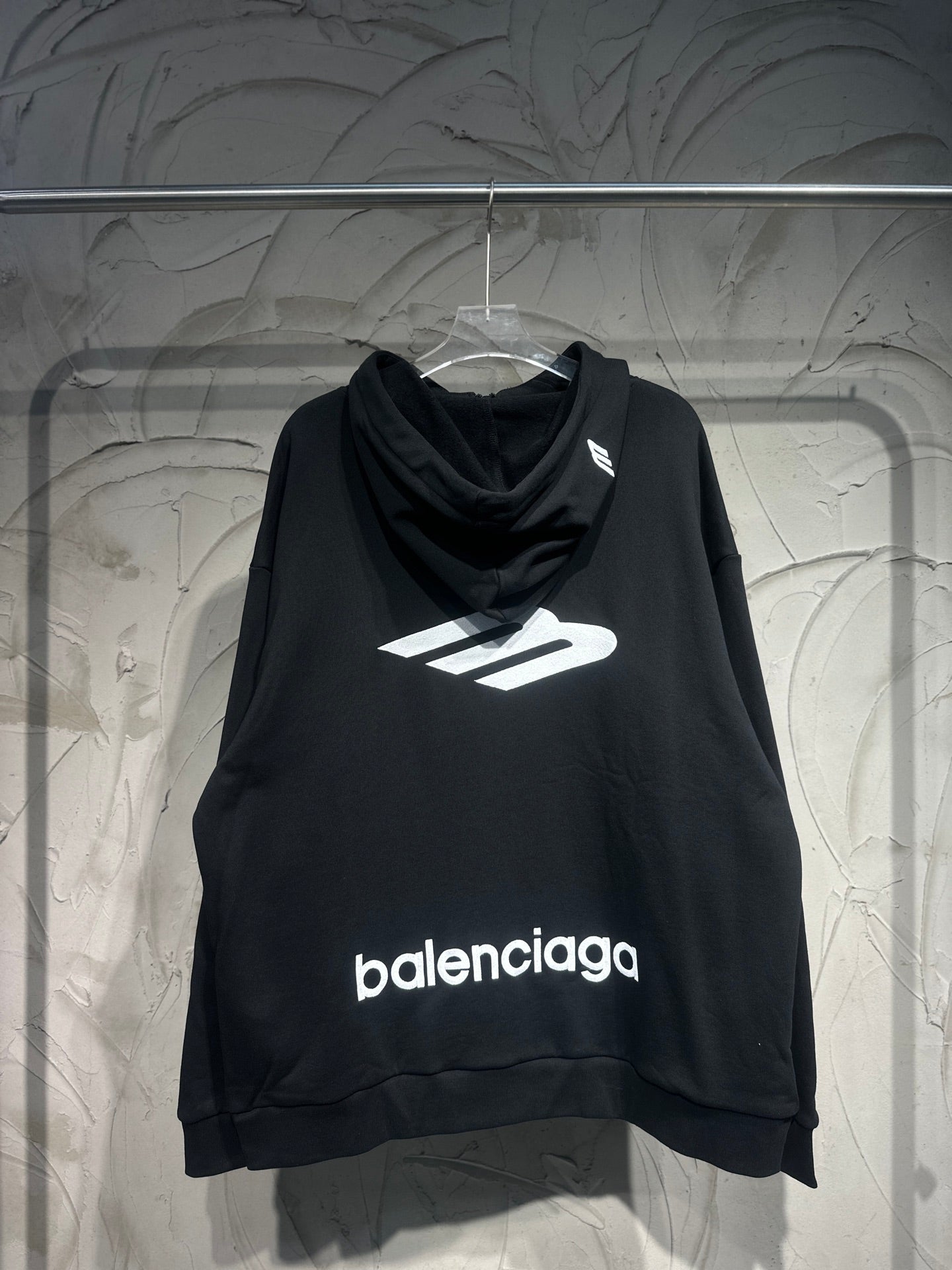Black Balenciaga hoodie with front logo print and cowl neckline