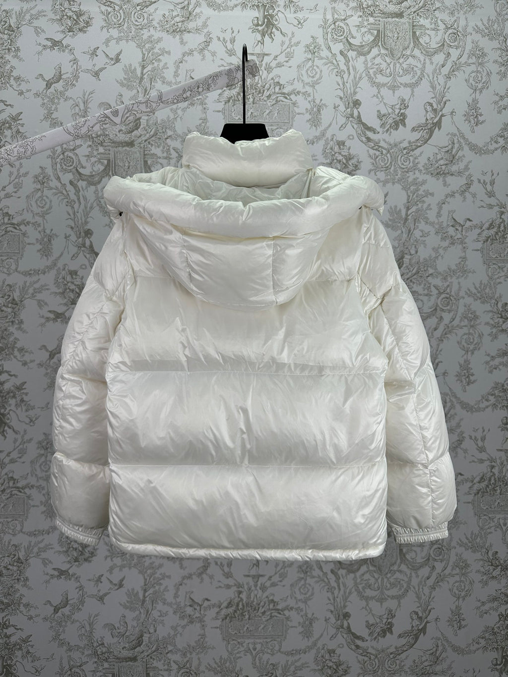 White long puffer jacket with attached hood and padded back