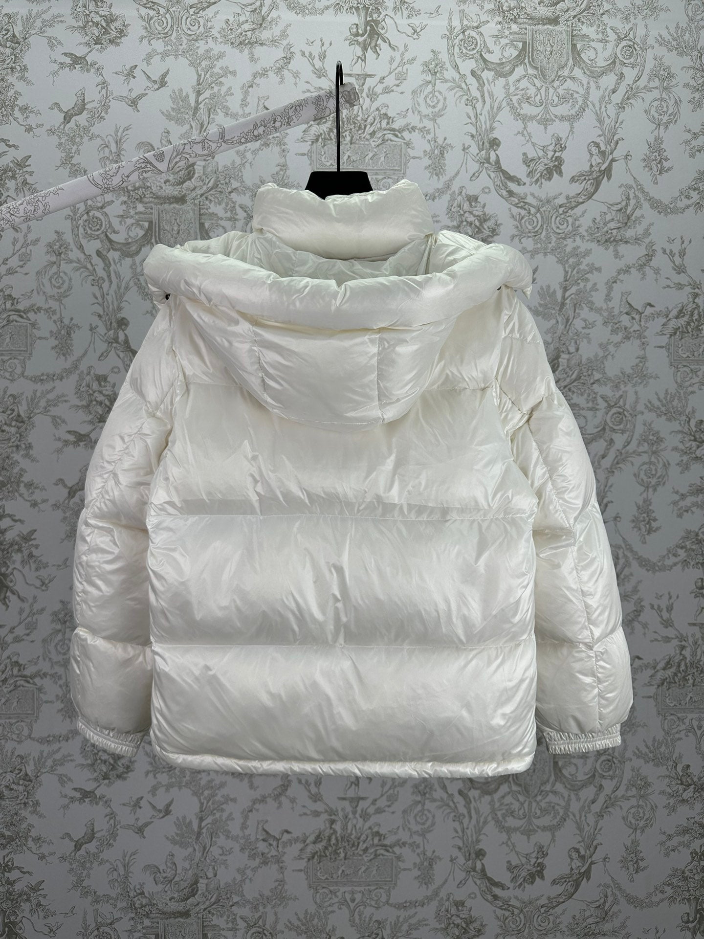 White long puffer jacket with attached hood and padded back