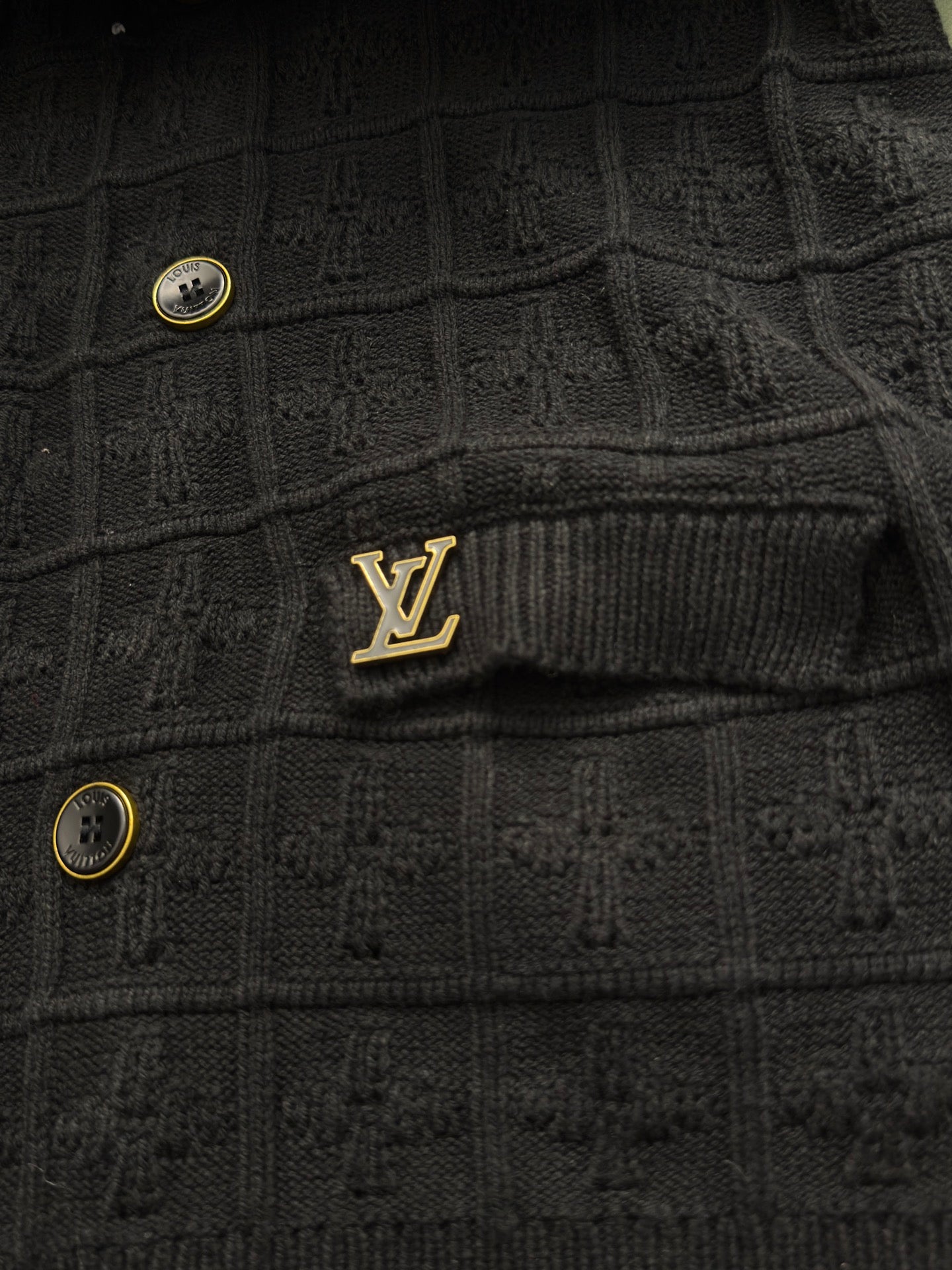 Black ribbed cardigan with small Louis Vuitton logo patch and gold buttons