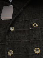 Black knit cardigan with textured pattern and gold-tone button accents