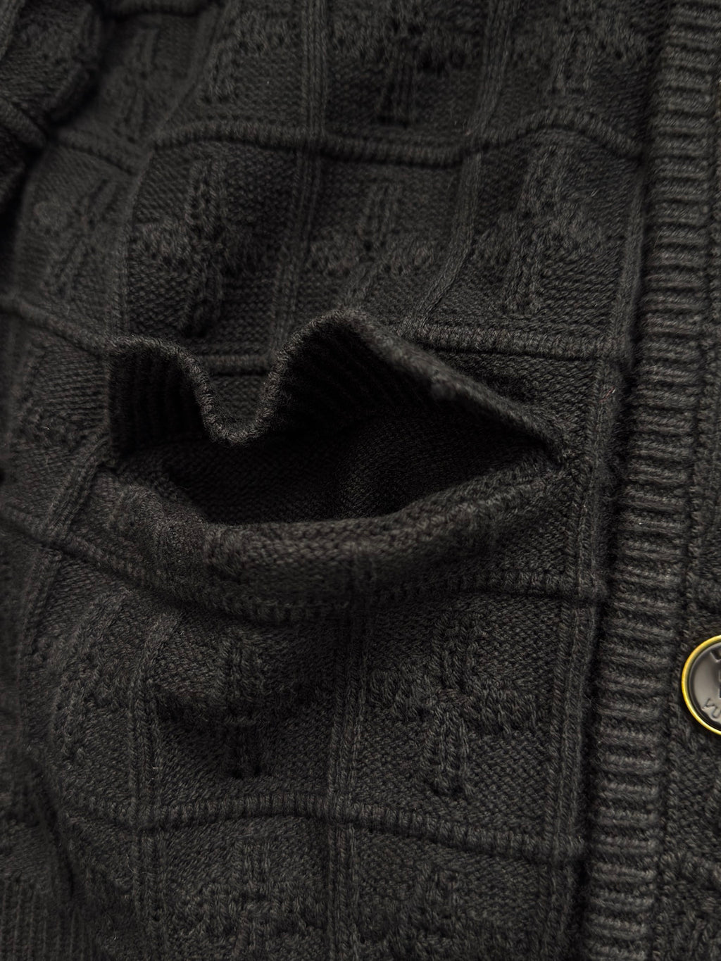 Black knit cardigan pocket detail with rib trim and stitched flap