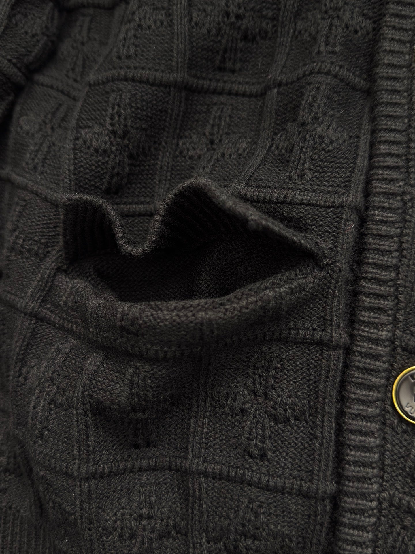 Black knit cardigan pocket detail with rib trim and stitched flap
