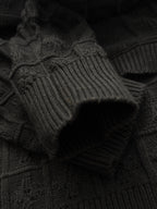 Black knit sleeve with ribbed cuff and textured stitched pattern