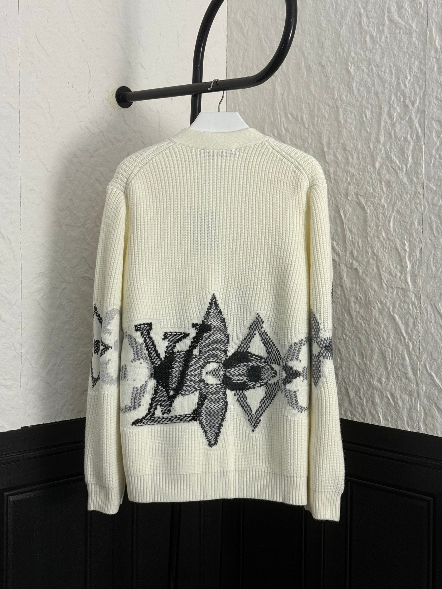 Cream rib-knit cardigan back with black geometric star graphic panel
