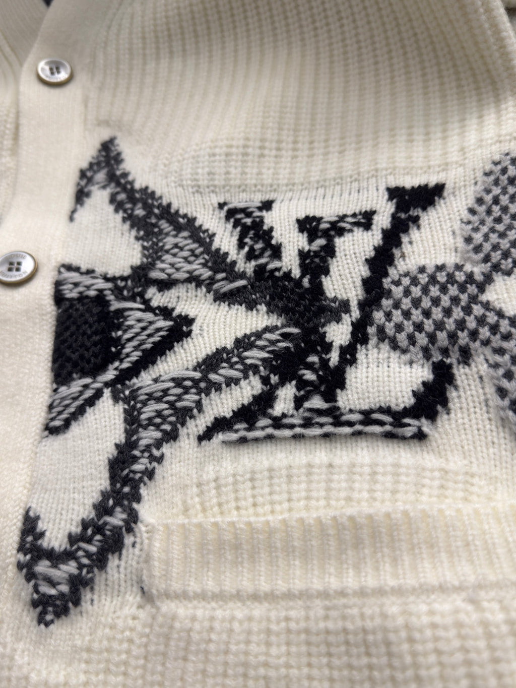 Cream knit cardigan yoke with black embroidered starburst detail and two buttons