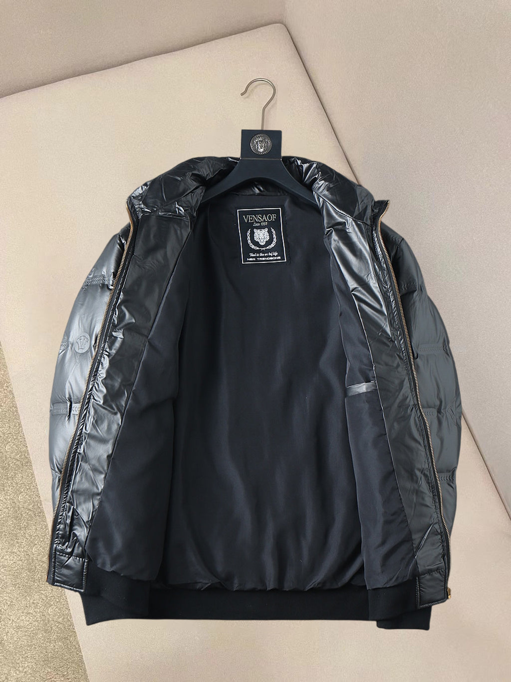 Hooded padded jacket back with central logo patch and quilted texture