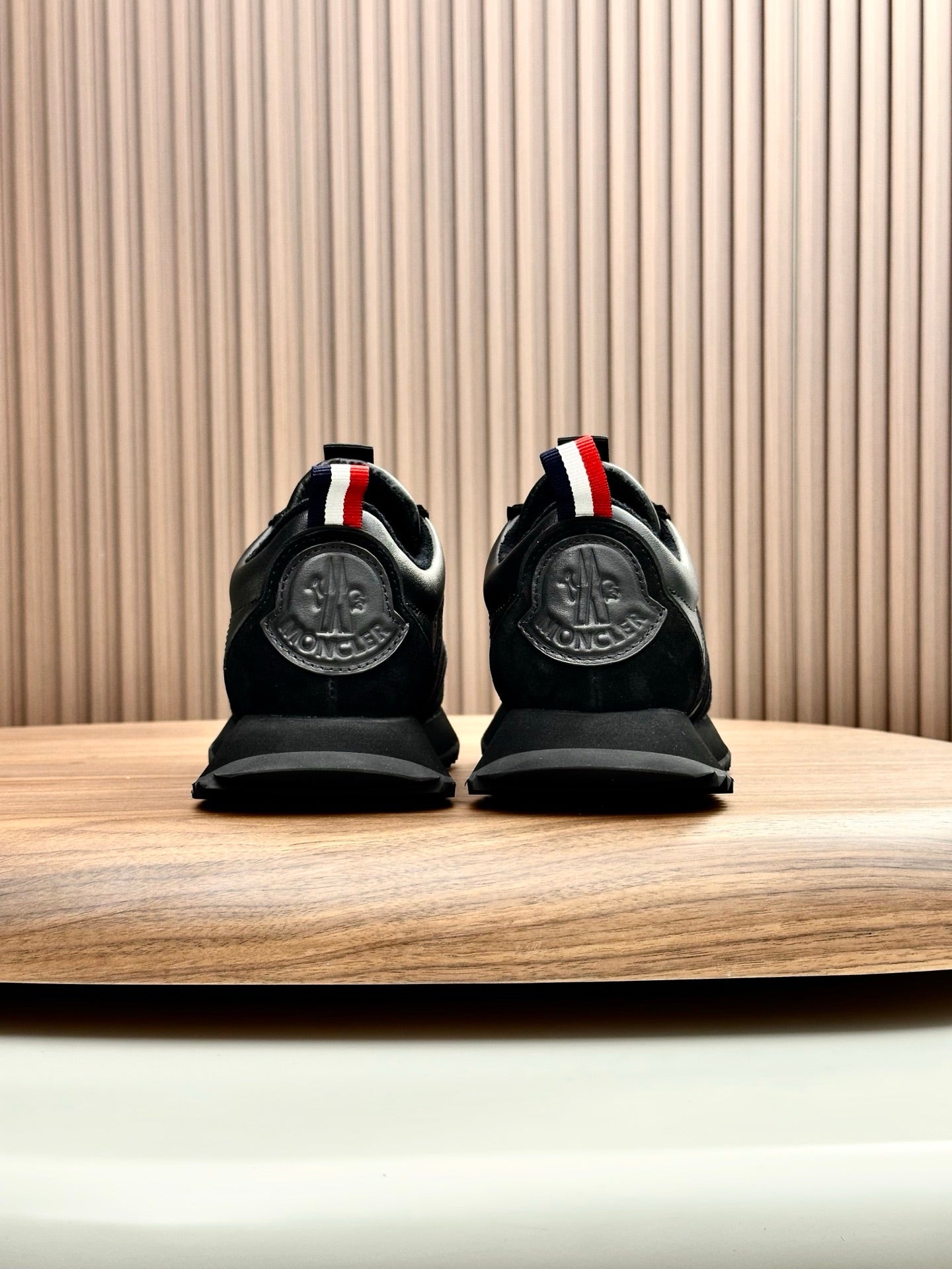 Moncler black sneakers back view with red-white-blue heel stripe