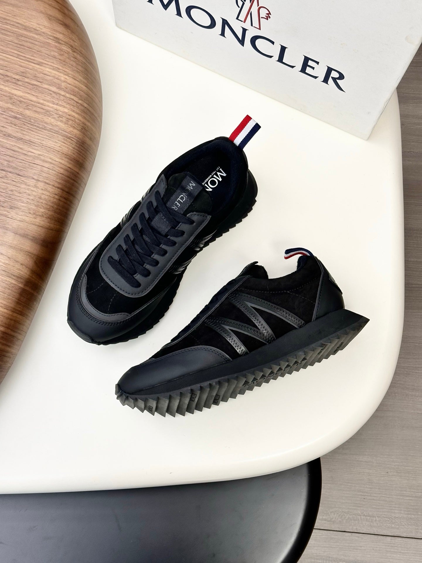 Moncler black sneakers with chunky sole and lace-up side stripes