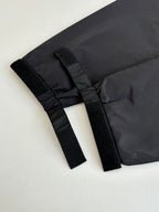 Black puffer jacket cuffs with adjustable strap tabs