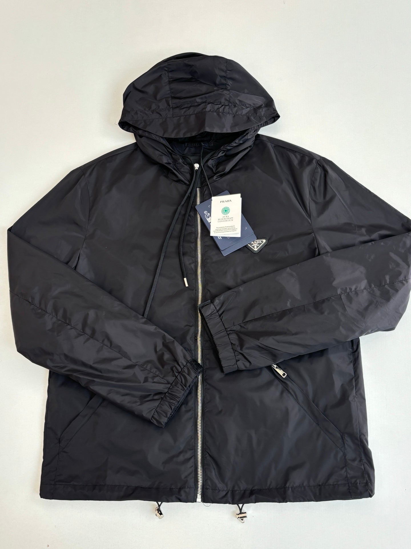Prada dark hooded puffer jacket with front zipper and interior label tags