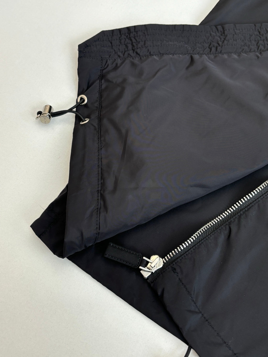 Prada jacket close-up of adjustable drawcord and zipper seam on sleeve