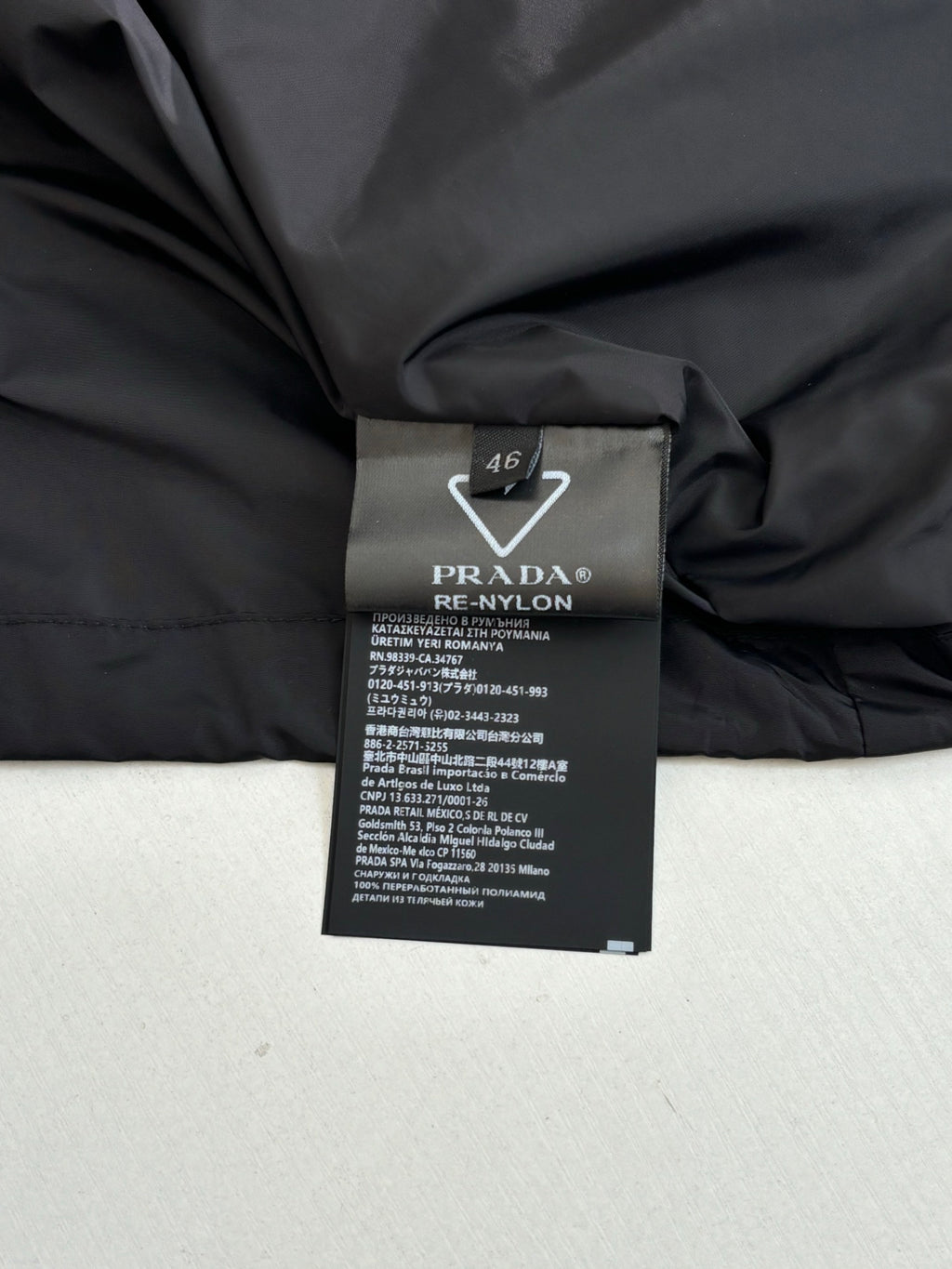 Black long jacket interior with Prada Re-Nylon label, size 46