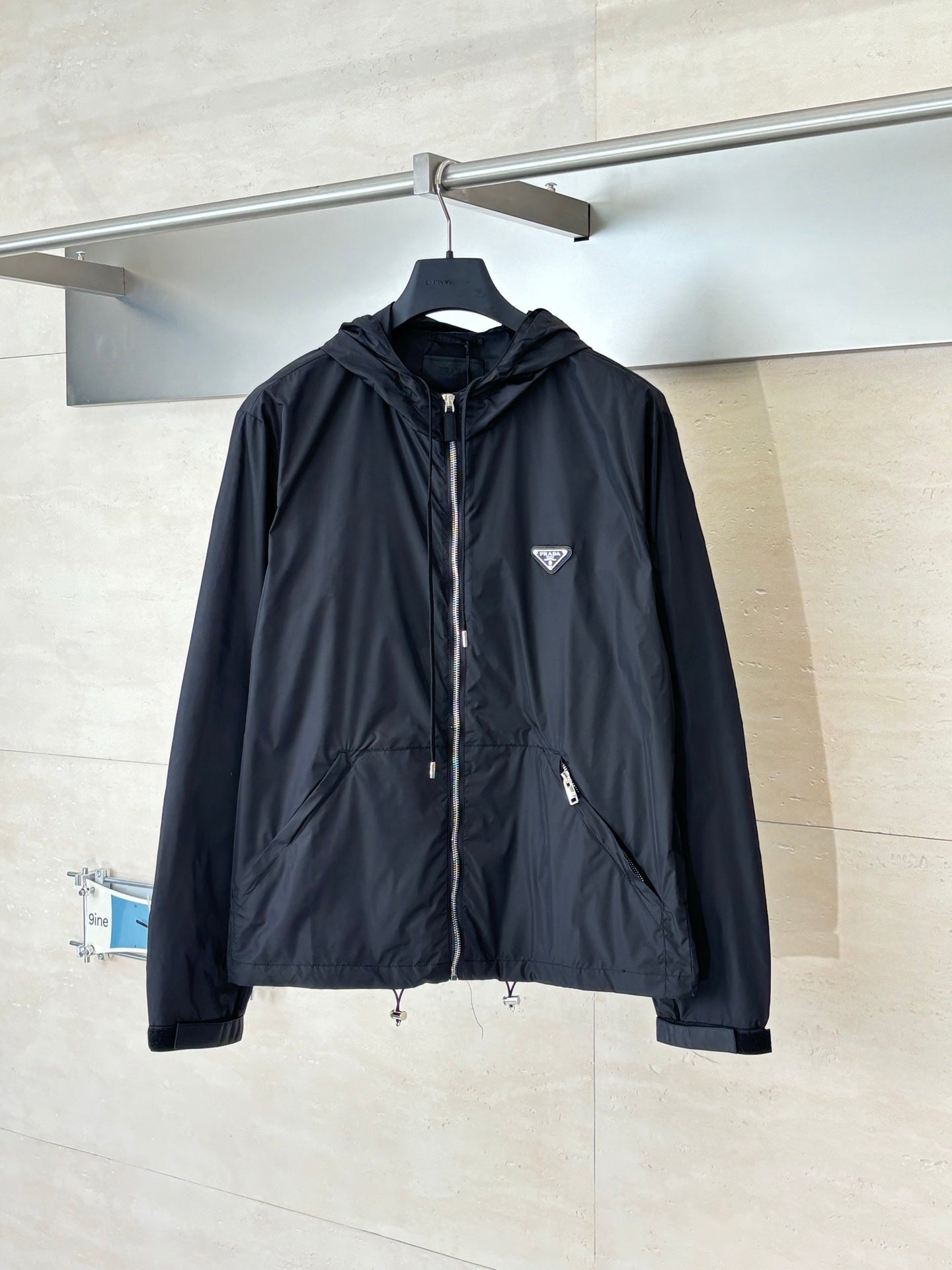 Prada dark hooded jacket with full front zipper and snap-tab chest pocket