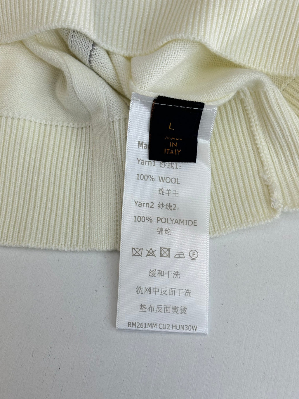 Inside neck care label reading 100% wool and 100% polyamide blend