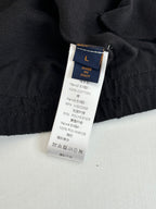 Black long garment fabric label with size L and material details