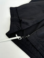 Dark navy jacket fabric detail with elastic cuff and zipper