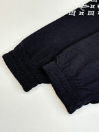 Dark navy elastic-cuff pants, gathered hem detail