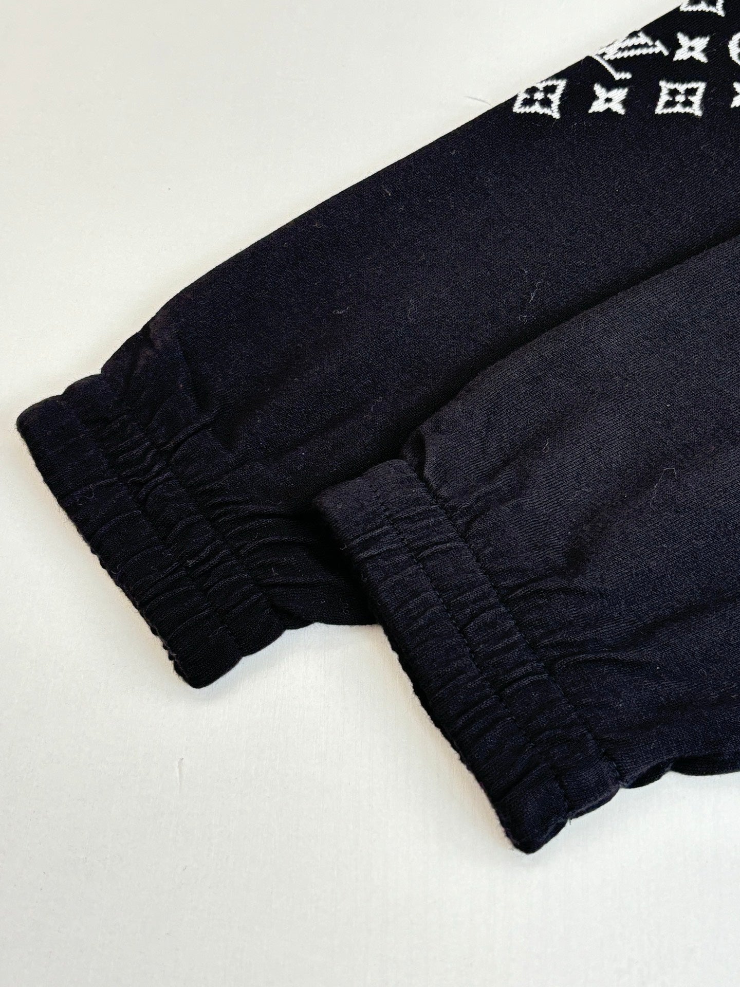 Dark navy elastic-cuff pants, gathered hem detail