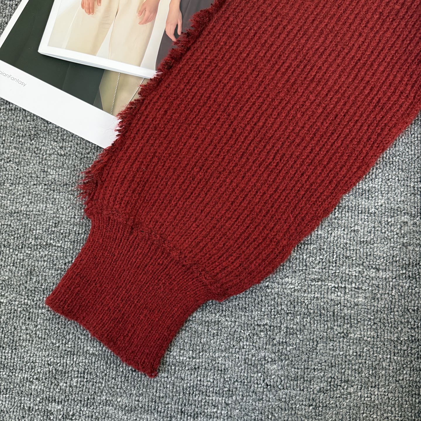 Burgundy ribbed knit sleeve cuff with soft frayed trim