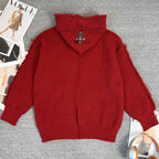 Burgundy knit hoodie with oversized hood and small logo cross emblem on chest