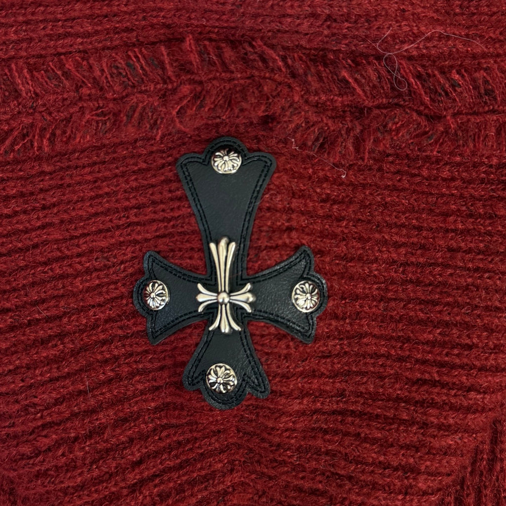 Burgundy knit hoodie with black cross emblem and white decorative accents