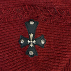 Burgundy knit hoodie with black cross emblem and white decorative accents