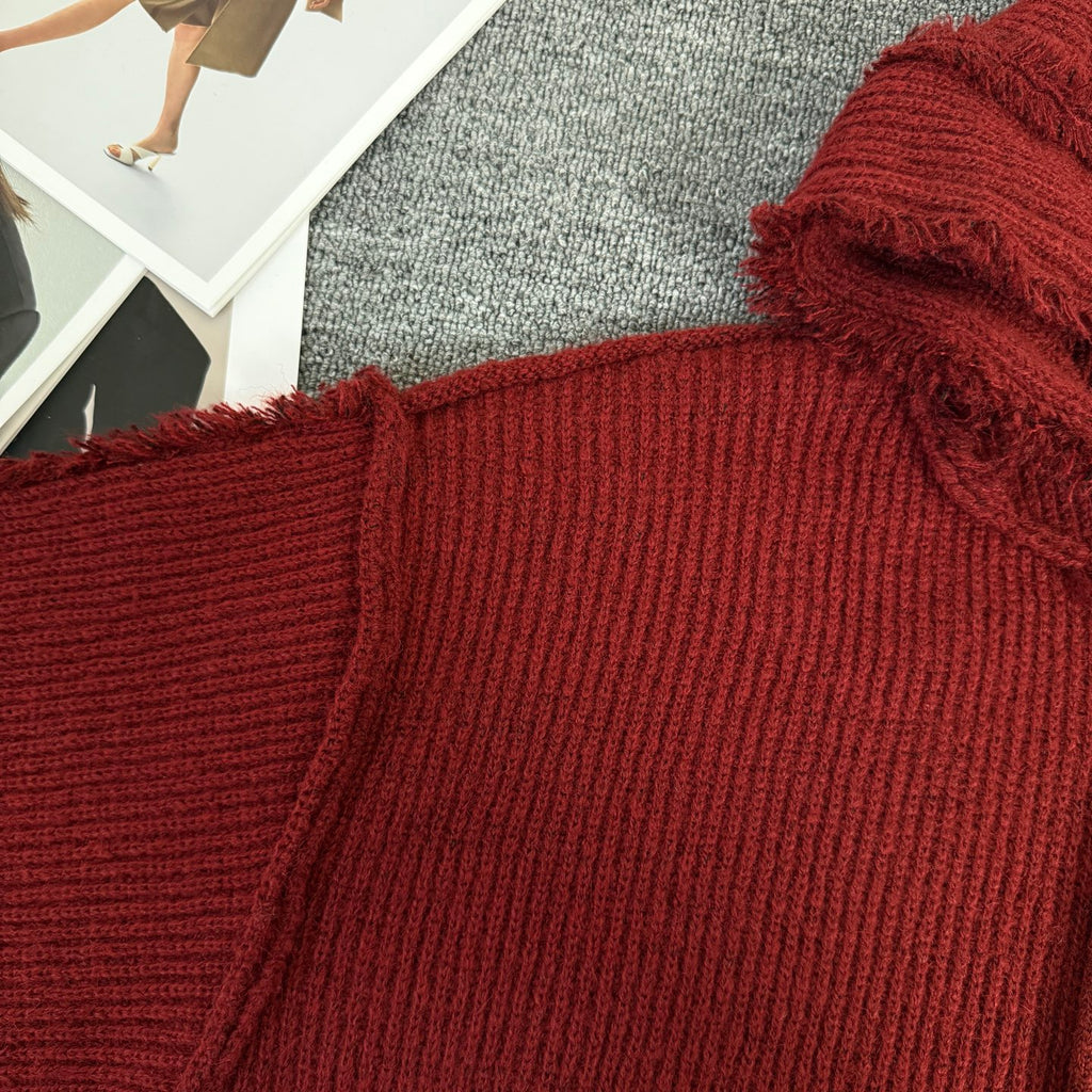 Burgundy knit hoodie close-up of shoulder and textured ribbed fabric