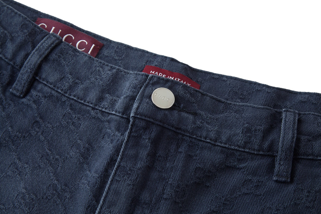 Gucci waistband closeup with silver button and Made in Italy tag