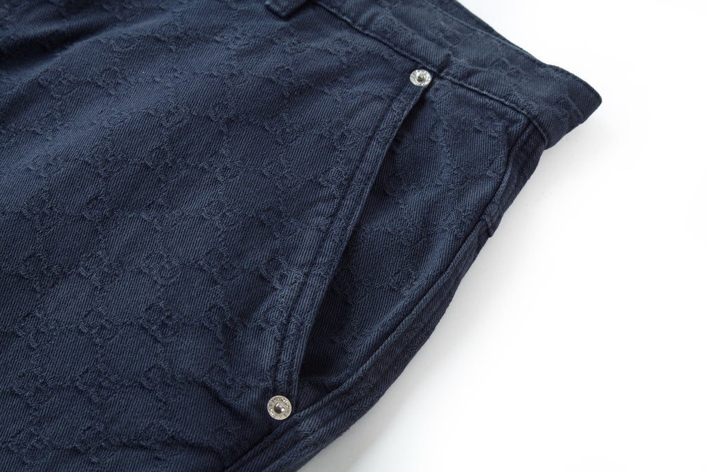 Navy wide-leg pants hem with button tabs and textured jacquard weave