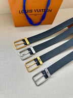 Louis Vuitton belt set with gold, silver, and black buckles on navy embossed straps.