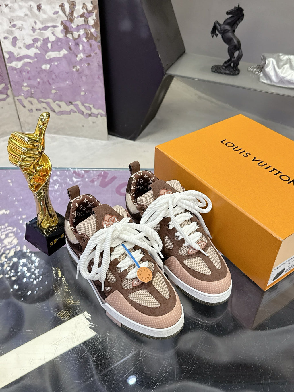 Women's Louis Vuitton low-top sneakers, front view, brown with white laces and monogram detail