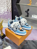 Pair of blue Louis Vuitton women’s sneakers with white laces on display box